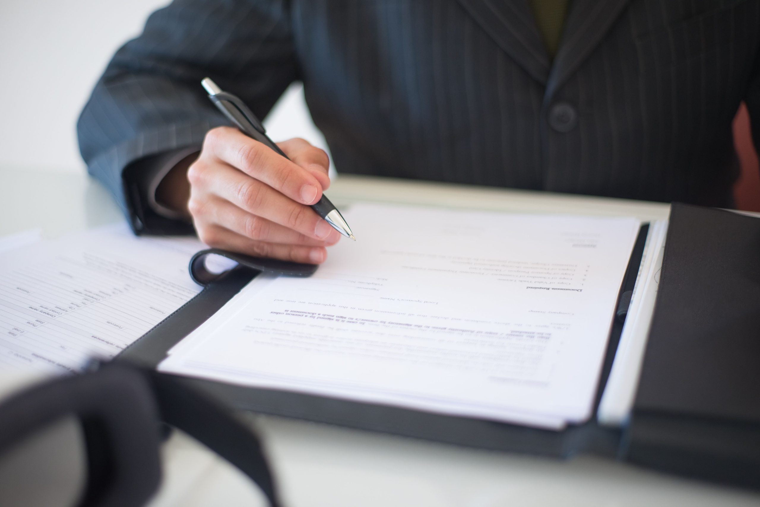 Main signant des documents représentant un contrat important